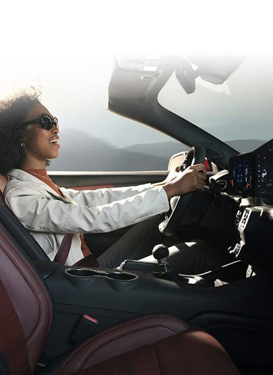Person sitting in the driver’s seat of a 2024 Ford Mustang® convertible | Fox Ford Inc. in Wolf Point MT