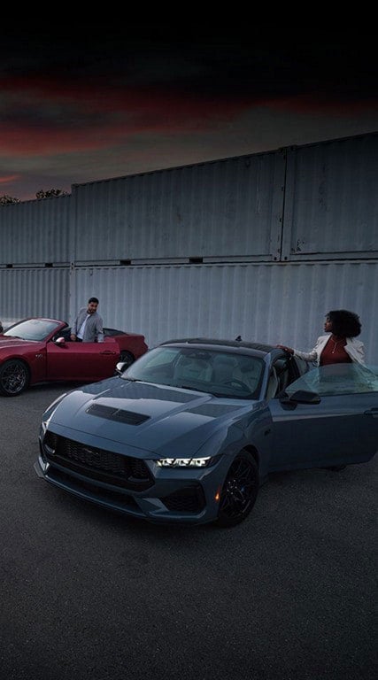 Two people exiting their parked 2024 Ford Mustang® coupe and convertible | Fox Ford Inc. in Wolf Point MT