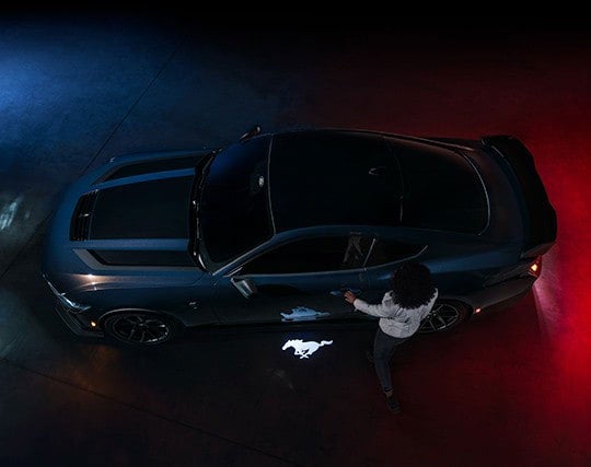 2024 Ford Mustang® Dark Horse™ model with a driver approaching the vehicle | Fox Ford Inc. in Wolf Point MT