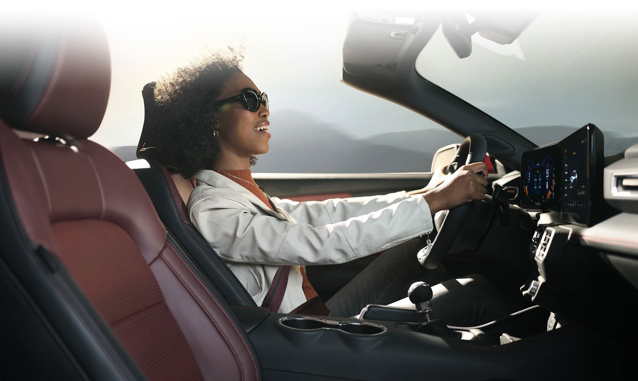 Person sitting in the driver’s seat of a 2024 Ford Mustang® convertible | Fox Ford Inc. in Wolf Point MT